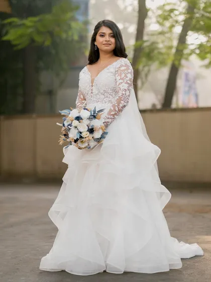 A full-length portrait of the bride in her beautiful A-line wedding gown.