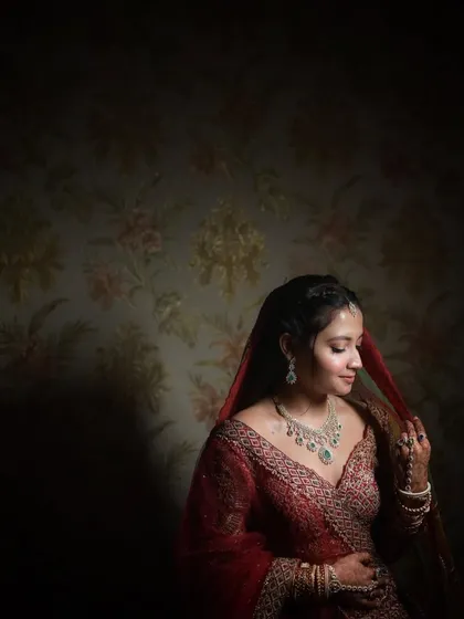 A moody and artistic bridal portrait. I used dramatic lighting here to sculpt the bride's features and create a sense of quiet contemplation, with the dark, patterned background adding to the atmosphere.