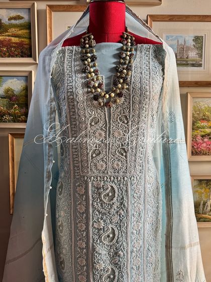 A full view of the powder blue suit on a mannequin, showcasing its serene and sophisticated color palette.