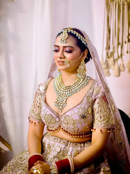 A beautiful candid portrait of the bride during her getting ready session. Her eyes are closed, and she has a peaceful smile, looking absolutely radiant.