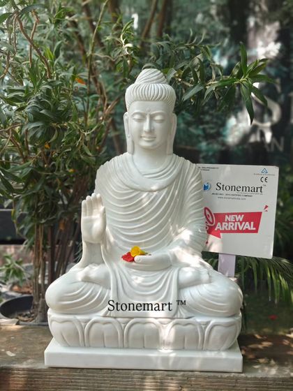 The pure white marble of this 3-foot Buddha statue gleams in the light. This piece is carved in the Abhaya Mudra posture, offering blessings and serenity.