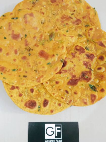 A close-up of my fresh and crispy Methi Thepla. You can see the specks of fresh fenugreek leaves and spices that make this flatbread so flavorful and healthy.