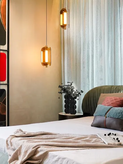 We envisioned this master bedroom as a sanctuary of comfort and character. A sage-green upholstered bed anchors the space, complemented by a sculptural, artistic headboard and warm ambient lighting, creating a room that feels both elegant and deeply personal.