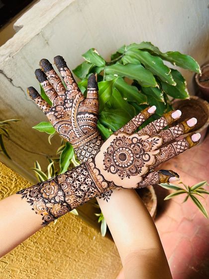 A crossed-hands pose showing the beautiful flow of the design from the back of the hands to the fingers.