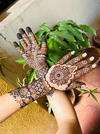 A crossed-hands pose showing the beautiful flow of the design from the back of the hands to the fingers.