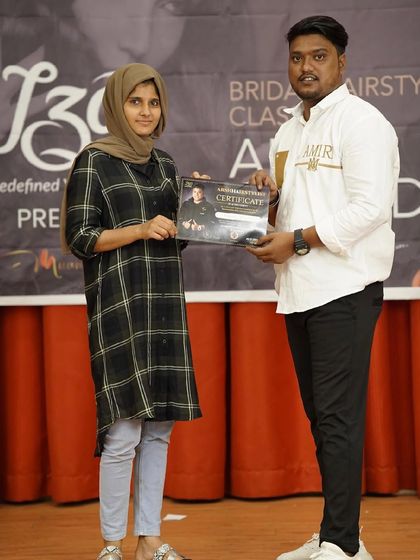 Another student receiving her certificate at a bridal hairstyling class.