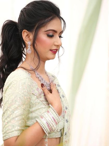 My pretty client Vibhuti ready for her event. Her pastel green outfit is paired with a high ponytail and soft, glowing makeup.