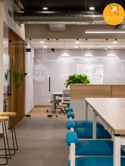 A view of the collaborative zones at Brandman. We use glass partitions and open sightlines to maintain a sense of transparency and connection, while wooden slats add warmth and texture.