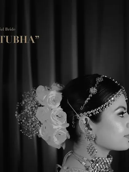 A moody, black and white bridal portrait that emphasizes emotion and elegance. This fine-art photography style focuses on profile shots, delicate jewelry, and floral hair accessories to create a truly artistic memory.