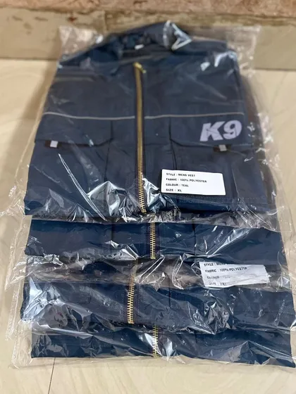 A close-up of the packaged vests. You can see the product label detailing the style and fabric, which is 100% polyester for durability and easy care.
