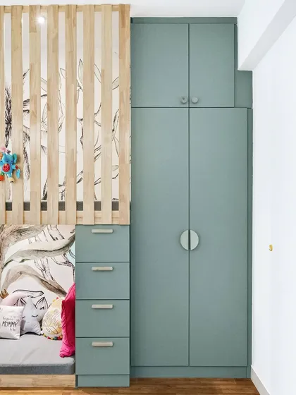 A close-up of the floor-to-ceiling wardrobe and loft bed structure, showcasing the clean lines and effective use of vertical space in the kid's room.