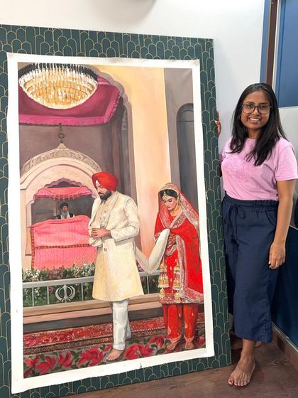 Here I am with a large-scale live wedding painting before it was shipped to the client in Australia. It's so rewarding to see the final piece ready to go to its new home.