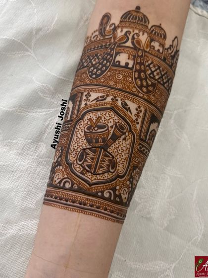 The arm band in progress, with the dhol-shehnai and kalash design beautifully detailed.