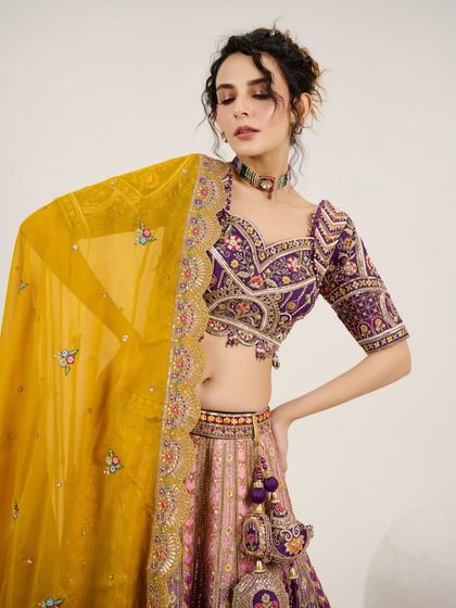 A close-up of the model in the multi-color lehenga, showing the detailed embroidery on the blouse.