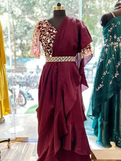 Another view of the designer ruffle saree, showcased next to an embroidered green gown, highlighting the variety in my occasion wear collection.