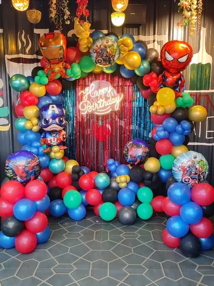 An action-packed Avengers theme for a birthday party. I built this balloon arch using the superhero colors of red, blue, green, and gold, and included foil balloons of Iron Man, Captain America, and Spider-Man.