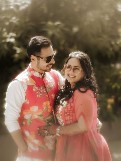 A relaxed and happy portrait. The couple's easy smiles and comfortable posture show their genuine connection, captured in a beautiful, sun-drenched setting.