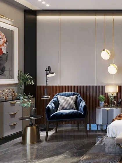 A cozy reading corner with a blue velvet armchair and modern art, creating a perfect spot to unwind.