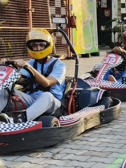 Get your game face on. Two drivers, buckled in and focused, waiting for the signal to start their race.