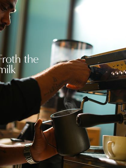 My barista expertly froths the milk, creating the perfect microfoam that is essential for a creamy latte and beautiful latte art.