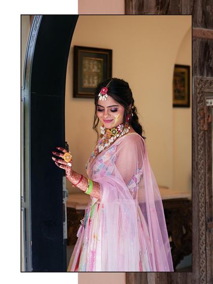 A beautiful Rajasthani bride during her Haldi ceremony, dressed in a lovely pink lehenga. This portrait captures her gentle smile and the festive glow.