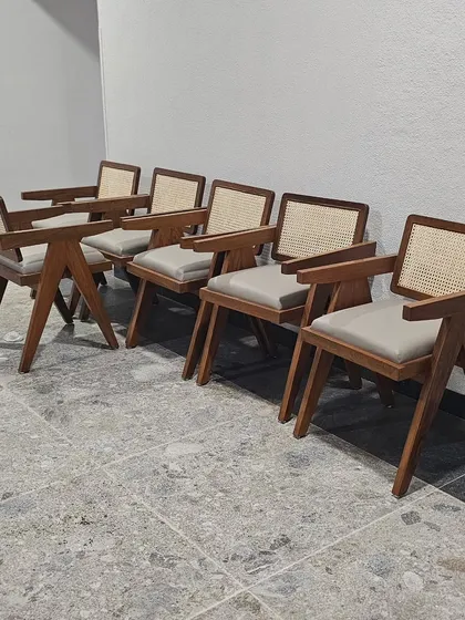 A set of teakwood chairs with cane backrests, ready for delivery. This design is inspired by the famous mid-century modern chairs of Chandigarh.