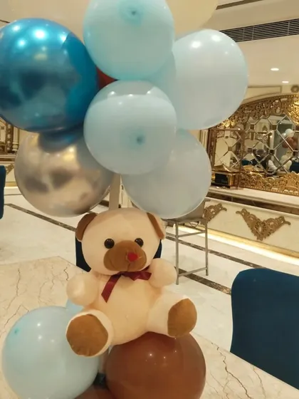 A cute teddy bear centerpiece for the guest tables, continuing the theme throughout the party space.