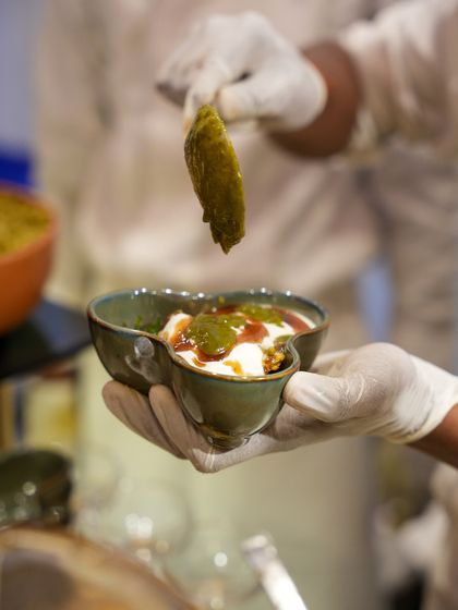 A modern take on Dahi Bhalla, with the chutney being artfully drizzled on top. We elevate even the most beloved street foods with our unique presentation.