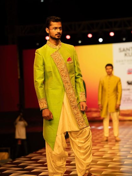 A full view of the runway look for Santhosh Kumar, showing the complete ensemble from head to toe.