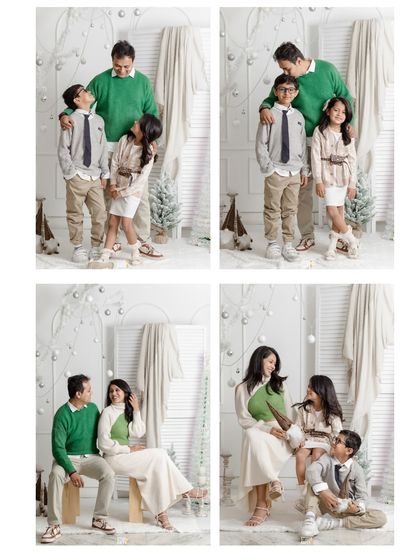 A classic Christmas family portrait. The family is dressed in festive green and white, sharing laughs and smiles in a beautifully decorated winter wonderland set in the studio.