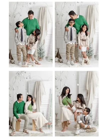 A classic Christmas family portrait. The family is dressed in festive green and white, sharing laughs and smiles in a beautifully decorated winter wonderland set in the studio.
