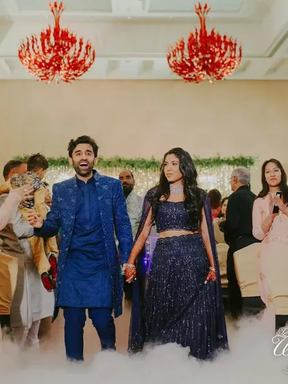 Walking on clouds. The couple makes their Sangeet entrance through a cloud of low-lying fog, adding a touch of dreamy magic to their grand arrival.