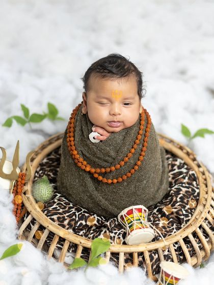 Even a slightly older baby, at 2.5 months, can be part of this theme. While he's more awake, his calm expression perfectly suits the 'adorable Mahadev' look.