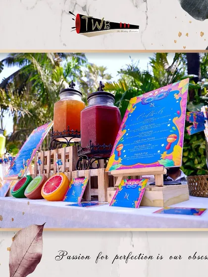A colorful mocktail bar setup for a brunch, featuring vibrant menus and fresh fruit dispensers.