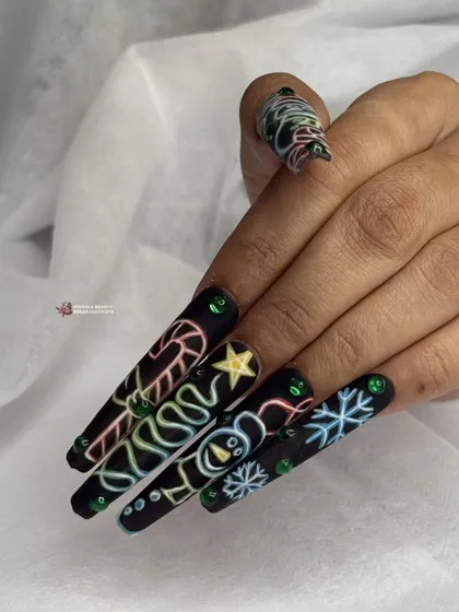 The neon Christmas nail art on a client's hand, showing the contrast between the bright colors and the dark, matte background.