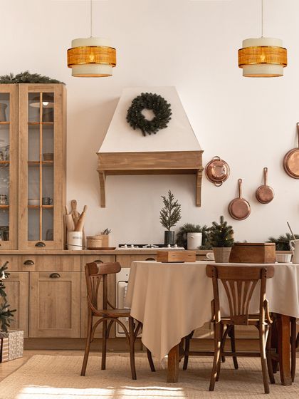 A pair of two-tiered woven pendants adds a touch of rustic charm to this festive kitchen. The lighting makes the space feel warm, inviting, and ready for celebration.