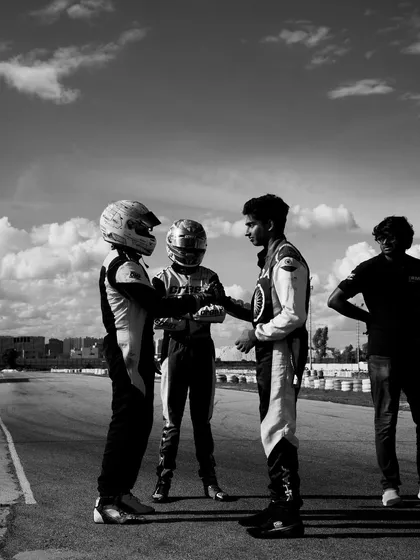 A black and white shot of our drivers showing sportsmanship on the track.