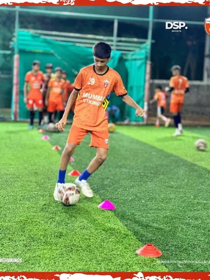 Precision is key. A young player navigates a cone drill at our Dombivili Gymkhana center, honing his close control.