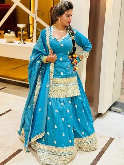 A full-length view of the blue sharara suit. The wide-legged pants are easy to move in, while the intricate gold work on the border and kurta adds a touch of traditional luxury.