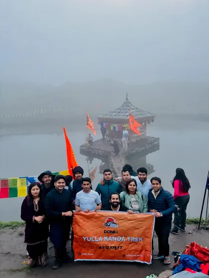 Our team at the Yulla Kanda trek, standing before the world's highest Krishna temple situated by a serene lake. A truly spiritual journey.