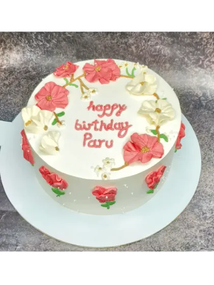 A pretty floral cake for Paru's birthday. This fresh pineapple cake is decorated with hand-piped cherry blossom-style flowers.