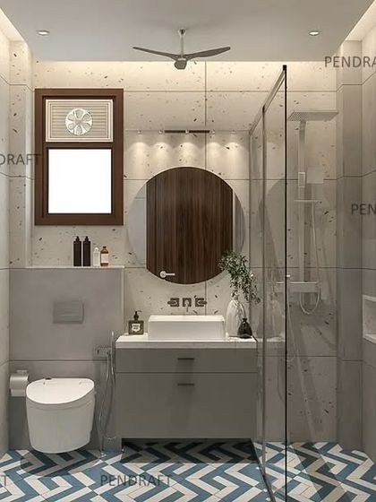 To make this small toilet feel more spacious and vibrant, we used a bold blue and white chevron pattern for the floor tiles, paired with simple, light-colored wall tiles.