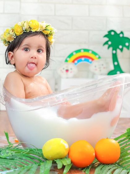 A funny face from the tub. This milk bath session, complete with a floral crown and citrus fruits, is a feast for the eyes.
