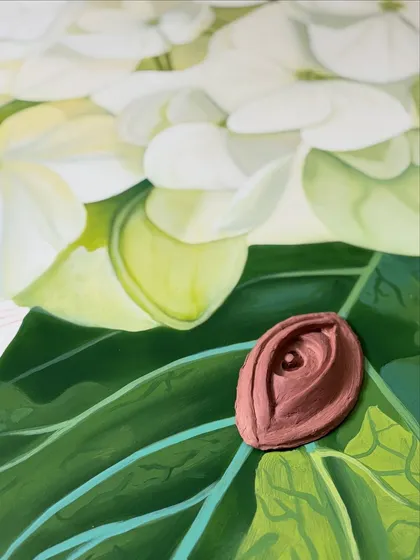 A painted clay eye nestled within the leaf of a hydrangea mural. The surreal detail invites viewers to look closer and discover the unexpected.