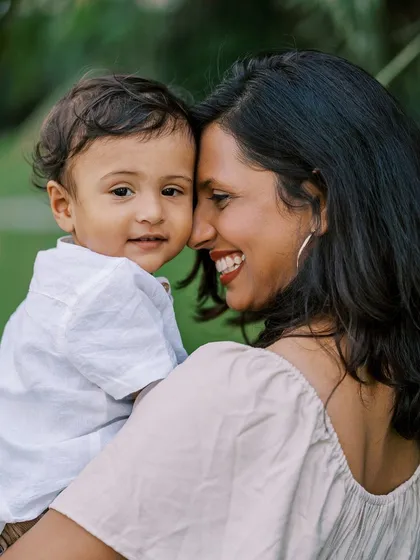 A sweet mother and son portrait, their heads close together. This image is full of warmth and maternal love.