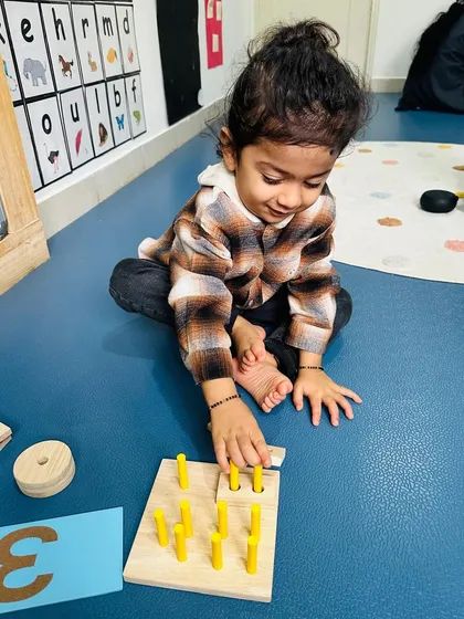 This is the ultimate goal of my training. A young learner is deeply focused on a numeracy puzzle, demonstrating how the play-based techniques I teach educators translate directly into engaged, confident, and curious children in the classroom.