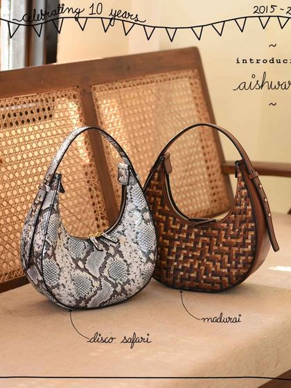 The Aishwarya bag, named after one of our patrons, is shown here in two stunningly different artistic edits. On the left, the bold Disco Safari print makes a modern statement, while on the right, the classic tri-color Madurai weave offers a timeless, textured look.