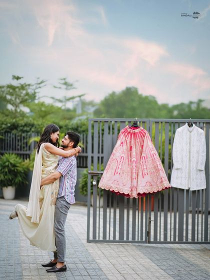 A joyful lift against the backdrop of their wedding attire. This shot is full of energy and happiness, perfectly capturing the excitement of getting married.