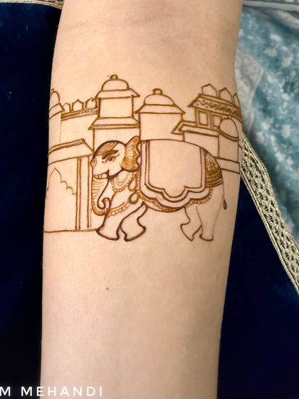 A traditional elephant motif, often symbolizing good luck and prosperity, drawn as part of a larger bridal piece. This is the clean outline before the intricate filling is added.