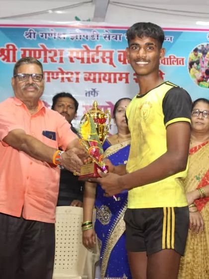 A player from our sub-junior team receiving an individual trophy at the Shri Ganesh Sports Club tournament.